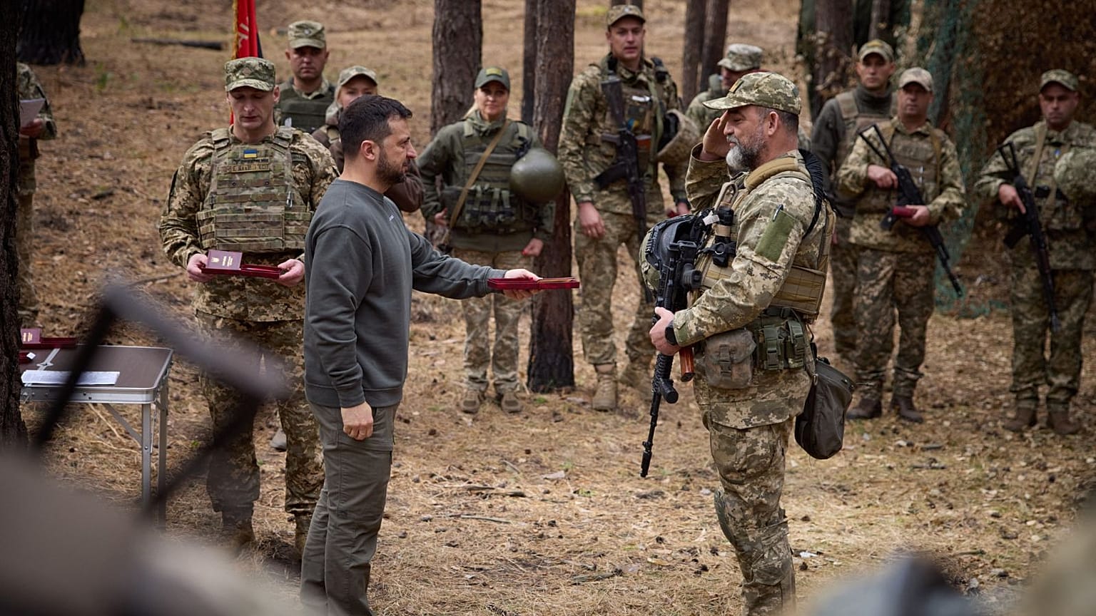 The Ukrainian President Volodymyr Zelenskyy presents an award to a serviceman during the visit. 