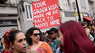 A protestor carries a poster during a demonstration to demand solutions for Portugal's housing crisis, in Lisbon, on April.