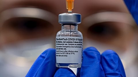Pharmacist Lena Springmann prepares a COVID-19 vaccination with Pfizer/BioNTech vaccine at a vaccination centre in Halle, Germany