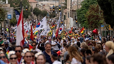 People participate in a traditional Jerusalem March during the Jewish holiday of Sukkot in Jerusalem on Wednesday, Oct. 4, 2023. 