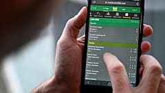 A man browses online gambling website Bet365 on a smartphone.