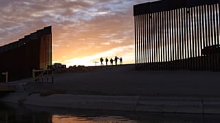 Archivo: familias migrantes de Brasil pasan a través de una brecha en el muro fronterizo para llegar a Estados Unidos. 10 de junio de 2021.