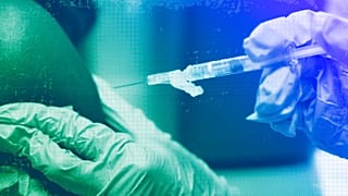 A pharmacist administers a Moderna Spikevax COVID-19 vaccine at a drug store, September 2023