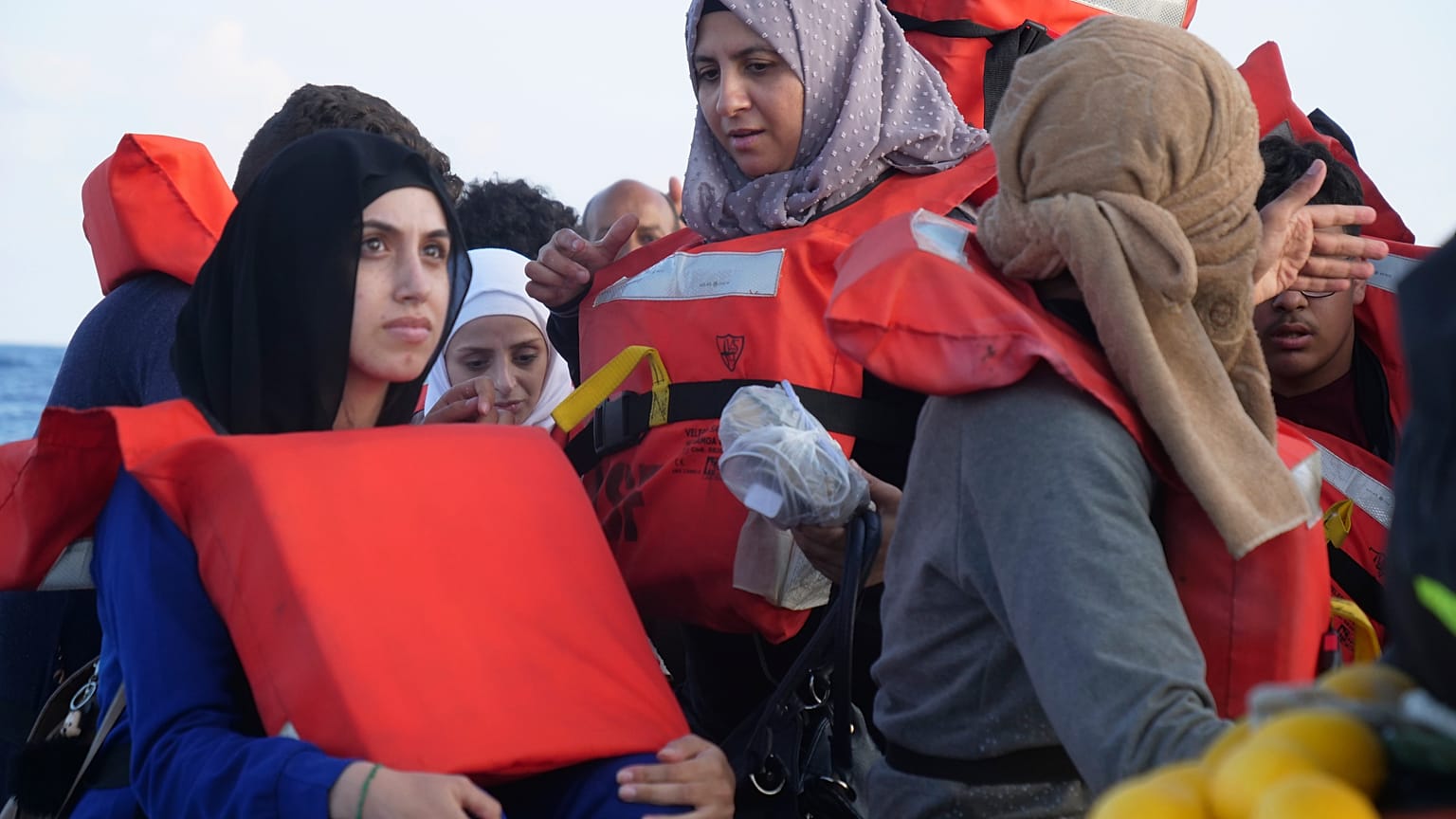 Migrants wear life vests as they are rescued by a MSF (Medecins Sans Frontiers) rescue team boat, after leaving Libya trying to reach European soil, on October 6.