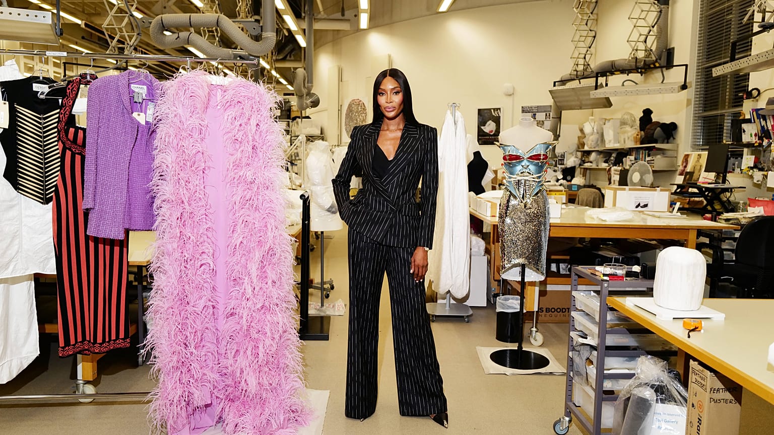 Supermodel Naomi Campbell poses with her clothes, which will be featured in a special exhibition at the V&A museum in London.