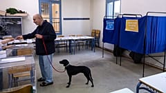 A man votes at a voting station during regional and municipal elections, in Athens