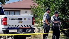 Fremont County deputies guard the road leading to the Return to Nature Funeral Home in Penrose, Colo. Thursday, Oct. 5, 2023.
