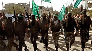 Masked Palestinian Hamas militant attend the funeral of Hamas militant Mahmmed Al Najar in the town of Khan Younis, southern Gaza Strip, Tuesday, Nov. 20, 2007.