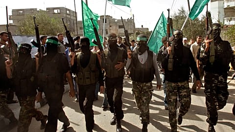 Masked Palestinian Hamas militant attend the funeral of Hamas militant Mahmmed Al Najar in the town of Khan Younis, southern Gaza Strip, Tuesday, Nov. 20, 2007.