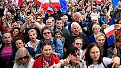 People cheers during a march to support the opposition against the governing populist Law and Justice party in Warsaw, Poland
