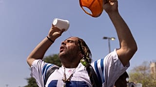 A man pours water atop his head outside the Emergency Aid Coalition during a heat wave in Houston, Texas, US, August 2023. 