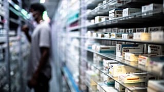 An employee stores medicines at a pharmacy in Paris, 2020.