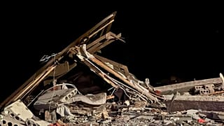 Oct. 12, 2023, shows a damaged house destroyed by debris of a Ukrainian drone that was shot down by Russian air defense outside Belgorod, Russia. 