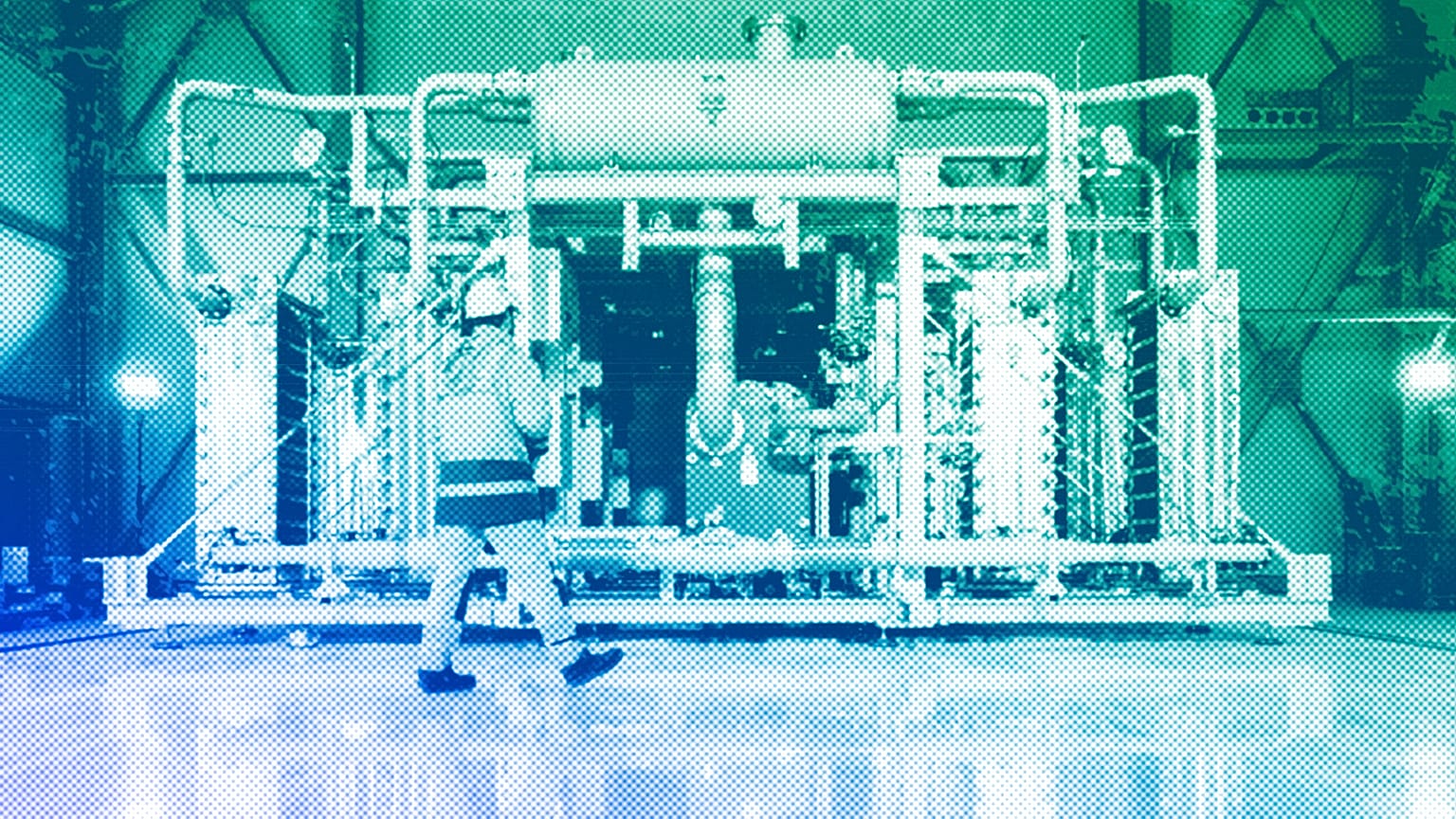 A worker walks in front of a electrolyzer for the production of green hydrogen in Oberhausen, May 2023