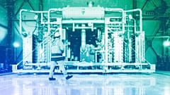 A worker walks in front of a electrolyzer for the production of green hydrogen in Oberhausen, May 2023