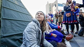 Climate activist Greta Thunberg joins activists wearing a traditional Sami outfits as they sit in protest outside the entrance of Statkraft, 12 October.