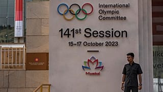 A security guard stands at the entrance of a venue ahead of the 141st International Olympic Committee (IOC) session in Mumbai, India.