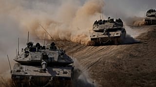 Israeli tanks head towards the Gaza Strip border in southern Israel on Friday, Oct.13, 2023.