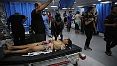 A Palestinian youth wounded in Israeli strikes is treated at Shifa Hospital in Gaza City, Friday, Oct. 13, 2023.