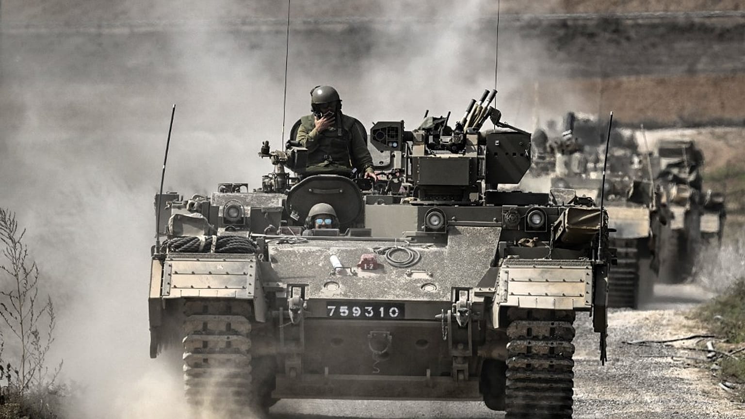 Israeli army Puma armoured personnel carrierss (APCs) move in a column near the Gaza border in southern Israel 
