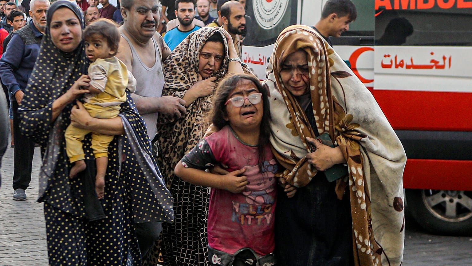 Wounded Palestinians arrive to al-Shifa hospital, following Israeli airstrikes on Gaza City on Monday
