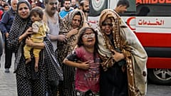 Wounded Palestinians arrive to al-Shifa hospital, following Israeli airstrikes on Gaza City on Monday