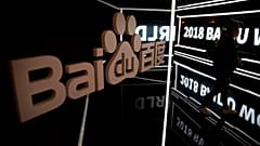 An attendee walks past a display at the Baidu World conference in Beijing