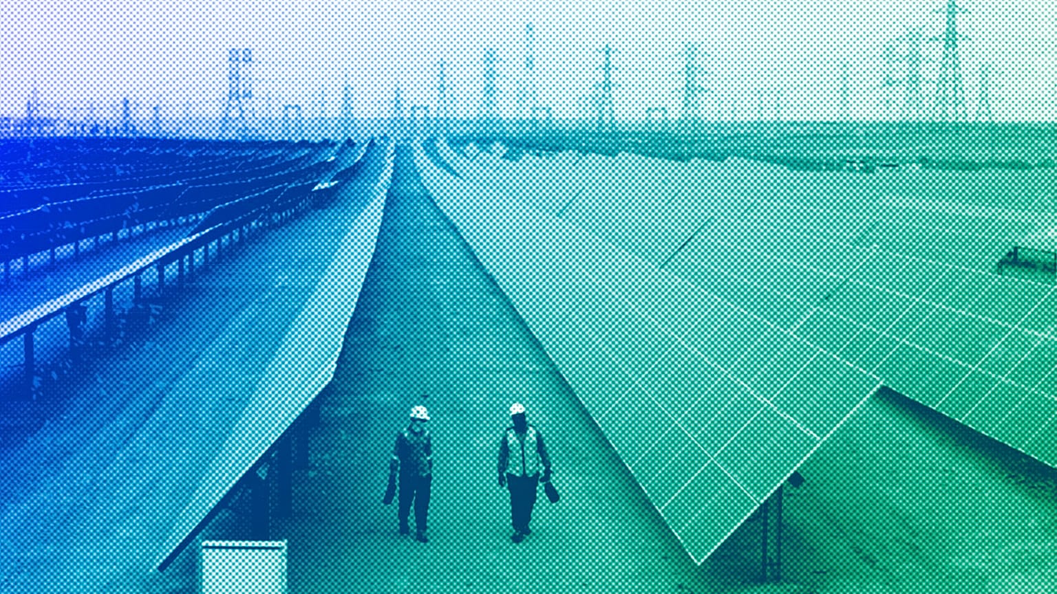 Engineers walk next to solar panels at Benban Solar Park in Aswan, Egypt, October 2022