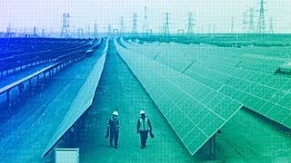 Engineers walk next to solar panels at Benban Solar Park in Aswan, Egypt, October 2022