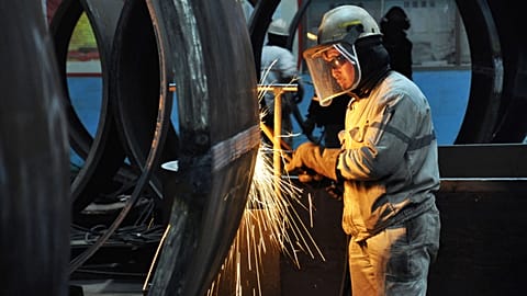 Chinese worker cutting steel in Qingdao in China's eastern Shandong province on January 18, 2018.