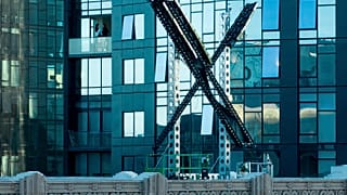 A partially completed "X" sign rests atop the company headquarters, formerly known as Twitter, in downtown San Francisco, on Friday, July 28, 2023