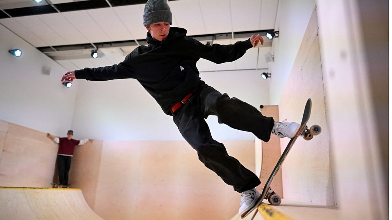 Riders from the Converse CONS Skateboard Team perform on the mini-ramp at the SKATEBOARD exhibition in London's design museum.