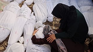 A woman reacts upon seeing the corpse of her sister, killed in an Israeli bombardment in Rafah in the southern Gaza Strip on Saturday