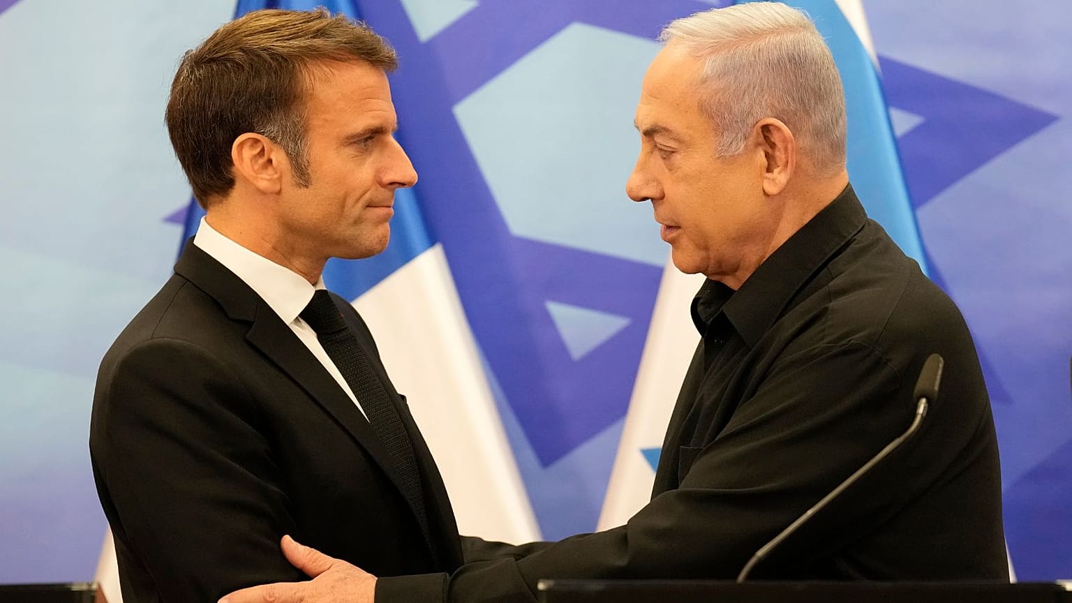 Israeli Prime Minister Benjamin Netanyahu, right, shakes hands with French President Emmanuel Macron after a joint press conference in Jerusalem, Tuesday, Oct. 24, 2023.