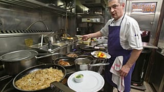 Chef Thierry Laurent prepares the plates in the kitchen of Bistro Paul Bert in the trendy 11th arrondissement of Paris, 2014.