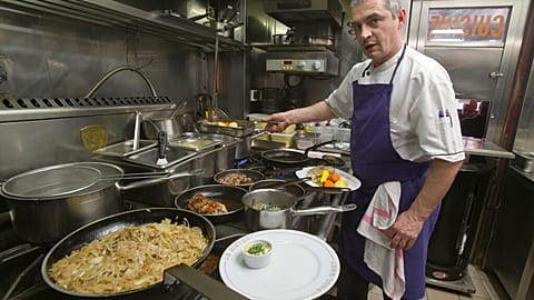 Chef Thierry Laurent prepares the plates in the kitchen of Bistro Paul Bert in the trendy 11th arrondissement of Paris, 2014.