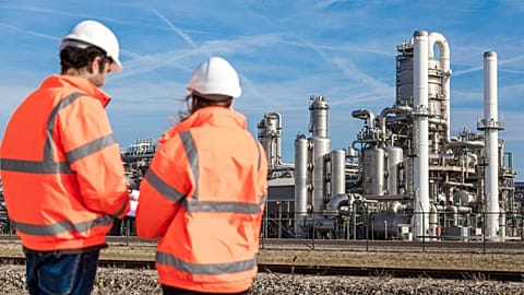 Workers in front of a chemical plant.
