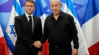 Israeli Prime Minister Benjamin Netanyahu, right, welcomes French President Emmanuel Macron before their talks in Jerusalem, Tuesday, Oct. 24, 2023.