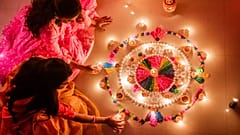 Women holding candles during Diwali festival