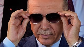 Turkish President Recep Tayyip Erdogan adjusts his sunglasses during a military parade in the Turkish occupied area of the divided capital Nicosia, Cyprus, Thursday, July 2023