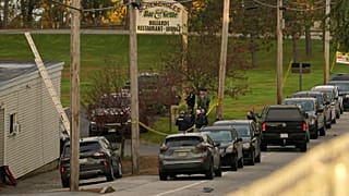 Law enforcement gather outside Schemengee's Bar and Grille, Thursday, Oct. 26, 2023, in Lewiston, Maine. 
