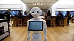 In this March 21, 2019 photo a robot called "Pepper" is positioned near an entrance to a Microsoft Store location, in Boston.