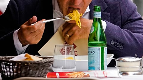 A man eats pasta in a restaurant in Milan, northern Italy, Thursday, June 8, 2023. Italians are calling for a pasta protest as food prices squeeze Europe.