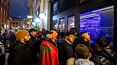 Football fans follow the World Cup quarterfinals outside a bar in Porta Venezia, Milan, Italy, 10 December 2022. 