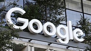 A Google sign hangs over an entrance to the company's new building, Sept. 6, 2023, in New York