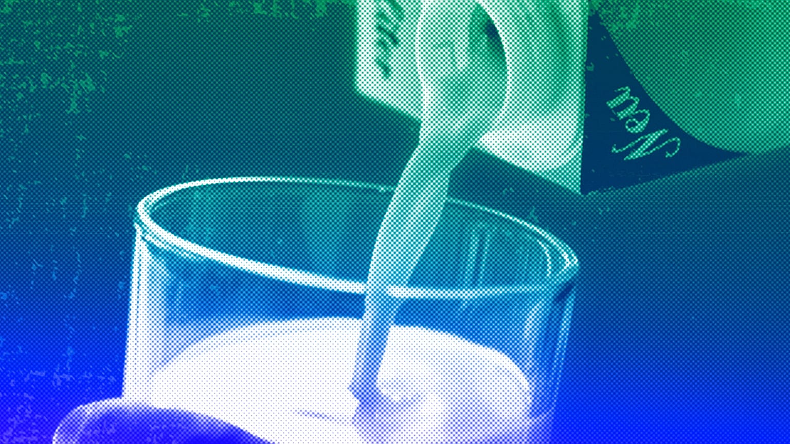 A person pours milk into a glass
