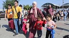 Palestinians cross to the Egyptian side of the border crossing with the Gaza Strip in Rafah Wednesday, Nov. 1, 2023.