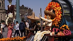 Visitors take photos of Day of the Dead themes presentations at Mexico City´s main square the Zocalo, Tuesday, Oct. 31, 2023.