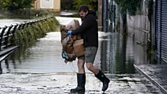In Newry, Nordirland, räumt ein Mann nach heftigen Regenfällen sein Geschäft