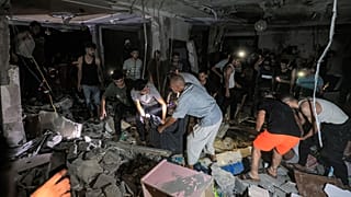 رجال الإنقاذ والناس يفتشون منزل الصحفي في تلفزيون فلسطين محمد أبو حطب